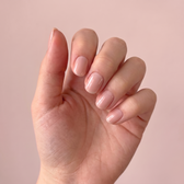 Bare Minimum press-on nails — styled hand angle