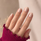 Crema press-on nails — styled hand angle
