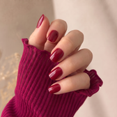 Sour Cherry press-on nails — styled hand angle