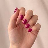 Cranberry press-on nails — styled hand angle