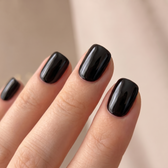 Jet press-on nails — glossy fingertip close-up
