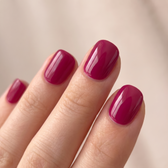 Cranberry press-on nails — glossy fingertip close-up