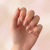 Butterscotch press-on nails — styled hand angle