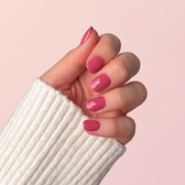 Terracotta press-on nails — styled hand angle