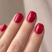 Red Flag press-on nails — glossy fingertip close-up