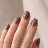 Chocoholic press-on nails — glossy fingertip close-up