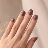 Chocoholic press-on nails — styled hand angle