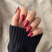 Sour Cherry press-on nails — styled hand angle