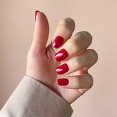 Red Flag press-on nails — styled hand angle
