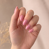 Strawberry Glaze press-on nails — styled hand angle