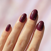 Sour Grape press-on nails — glossy fingertip close-up