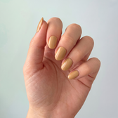 Sunkissed press-on nails — styled hand angle