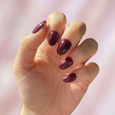 Sour Grape press-on nails — styled hand angle