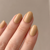 Sunkissed press-on nails — glossy fingertip close-up