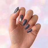 Phantom press-on nails — styled hand angle