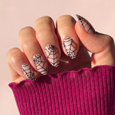 Cobweb press-on nails — styled hand angle