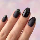 Black Cat press-on nails — glossy fingertip close-up