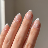 Snowfall press-on nails — glossy fingertip close-up