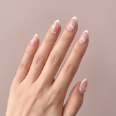 Snowfall press-on nails — styled hand angle